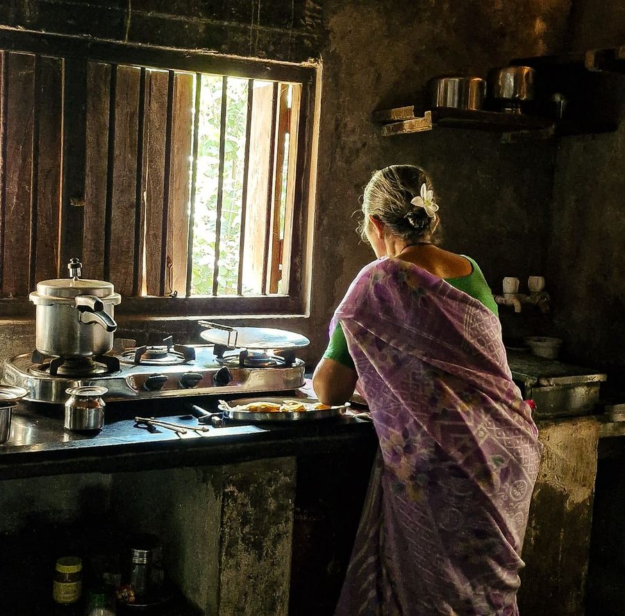 A cook preparing a meal in a traditional home kitchen